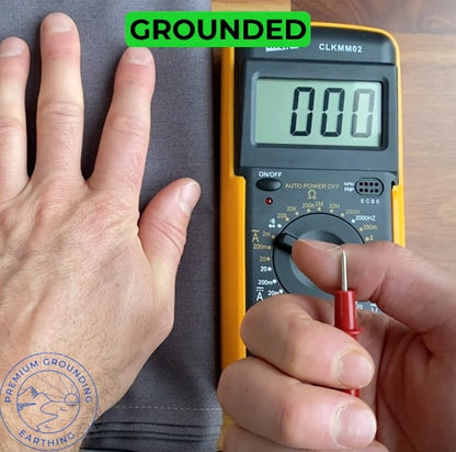 hand connecting to earthing mat getting grounding with multimetre